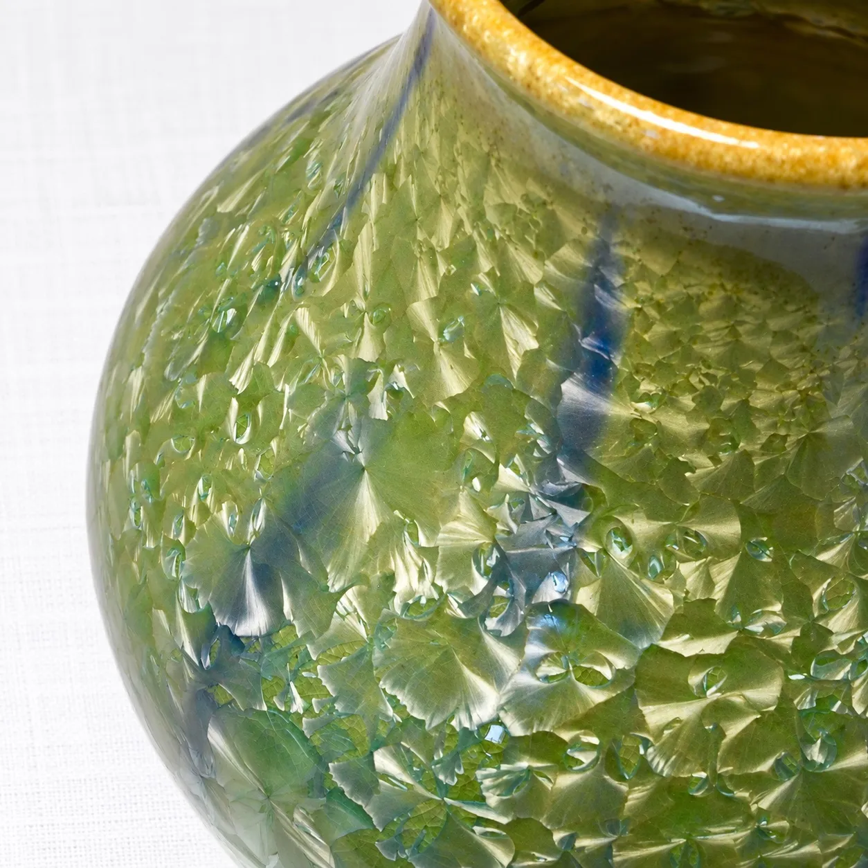 Close view of the glaze, pale fan-shaped green crystals with cobalt-blue rivulets